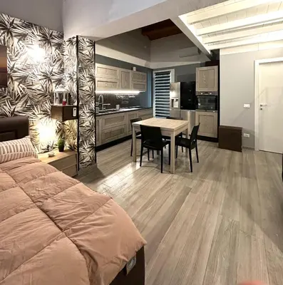 a bedroom with a bed and a table and chairs at Casa Luma Palermo in Palermo