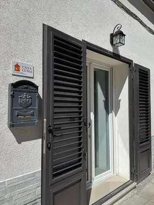 a door with a sign on the side of a building at Casa Luma Palermo in Palermo