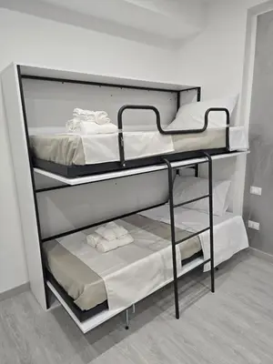 a couple of bunk beds in a room at La Mantia Luxury Rooms in Palermo