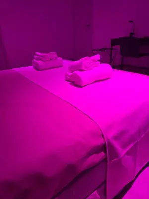 a bed with two pink towels on top of it at La Mantia Luxury Rooms in Palermo