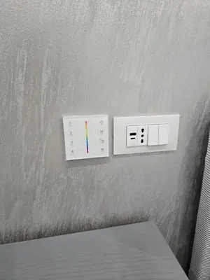 two light switches are on a wall at La Mantia Luxury Rooms in Palermo