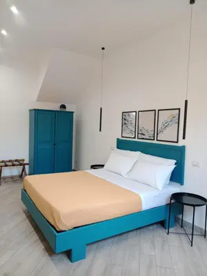 a bedroom with a blue bed and a blue cabinet at Blu di Sicilia in Palermo