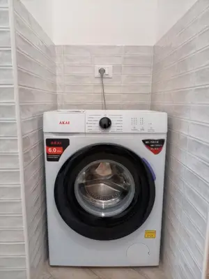 a washing machine in a corner of a room at Blu di Sicilia in Palermo