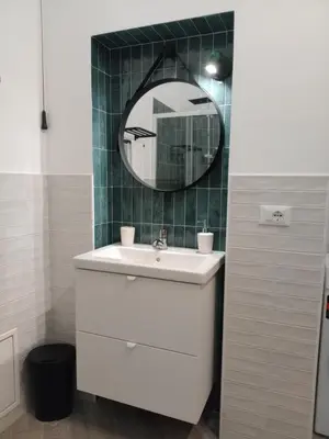 a bathroom with a white sink and a mirror at Blu di Sicilia in Palermo