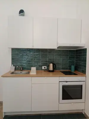 a kitchen with white cabinets and a sink at Blu di Sicilia in Palermo