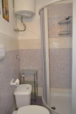a small bathroom with a toilet and a shower at Casa Colorata in Palermo
