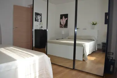 a mirror in a room with two beds in a room at Casa Colorata in Palermo