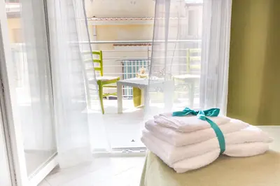 a pile of towels sitting on a bed in front of a mirror at Stanze del Mare in Balestrate
