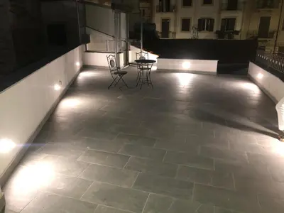 a patio with chairs and lights in a building at La Maison de Claude in Palermo