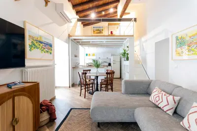 a living room with a couch and a table at Palazzo Castrone, Luxury Apartment in Palermo