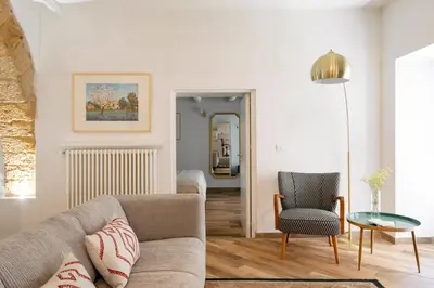 a living room with a couch and a chair at Palazzo Castrone, Luxury Apartment in Palermo