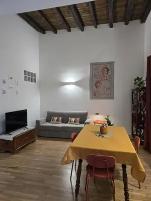a living room with a table and a couch at DorMimmo a Palermo, nel cuore pulsante della città! in Palermo