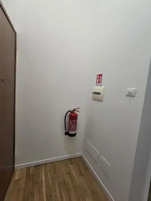 a room with a white wall with a fire hydrant on it at DorMimmo a Palermo, nel cuore pulsante della città! in Palermo
