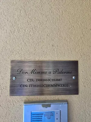 a sign that says donuminati a palmerphone on a wall at DorMimmo a Palermo, nel cuore pulsante della città! in Palermo