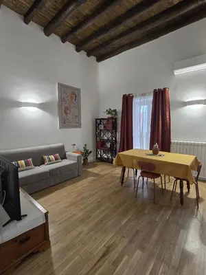 a living room with a table and a couch at DorMimmo a Palermo, nel cuore pulsante della città! in Palermo