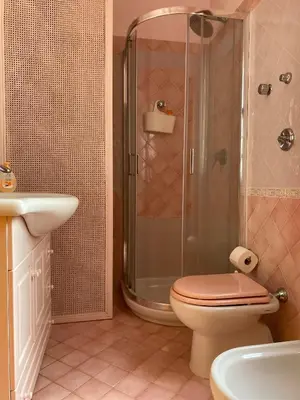 a bathroom with a shower and a toilet and a sink at Villa Glicine a pochi passi dal mare e dal centro in San Vito lo Capo