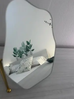 a bed with two pillows and a plant on it at Coco Memi Apartment in Palermo