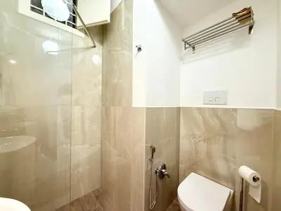 a bathroom with a shower and a toilet and a sink at Vicolo Giardi in Palermo