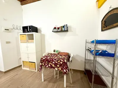 a room with a table and a bunk bed at Vicolo Giardi in Palermo