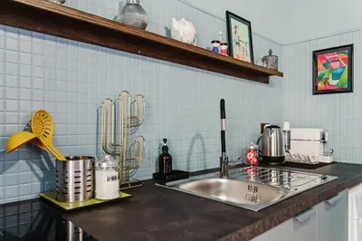 a kitchen counter with a sink in a kitchen at BallarHòme 105 