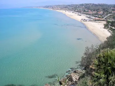 an aerial view of a beach and the ocean at La Casetta nel Porto in Castellammare del Golfo