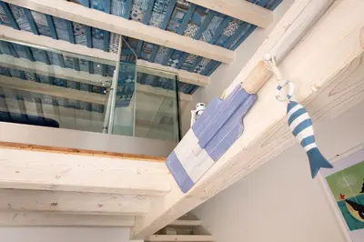 a hammock hanging from the ceiling of a house at La Casetta nel Porto in Castellammare del Golfo