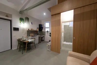 a kitchen and living room with a table and a dining room at A casa da Carlo al Borgo 2 in Palermo
