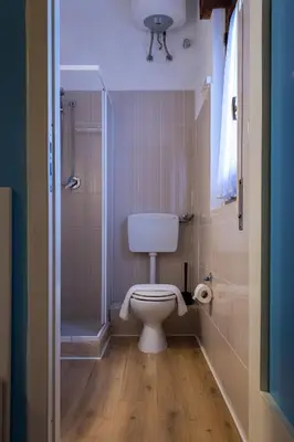 a small bathroom with a toilet and a shower at Affittacamere le scale in Castellammare del Golfo