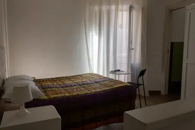 a small bedroom with a bed and a window at Affittacamere le scale in Castellammare del Golfo