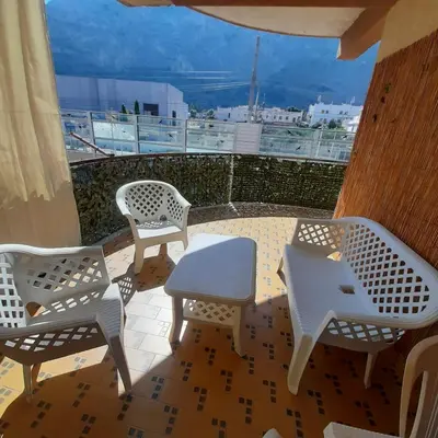 a patio with chairs and a table on a balcony at Rossy guest house 3 in Isola delle Femmine