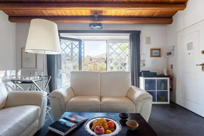 a living room with a couch and a bowl of fruit on a table at The Urban Retreat - Relax in the Historic Center in Palermo
