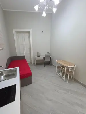 a small room with a bed and a table at Isti e Binisti Flat in Palermo