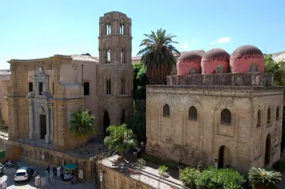 an old building with a tower and a church at Kalaciuri Rooms in Palermo