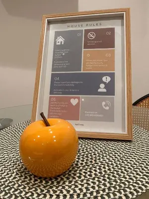 a orange sitting on a table next to a picture at SulCorsoRooms in Palermo
