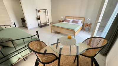 a room with a table and chairs and a bed at SulCorsoRooms in Palermo