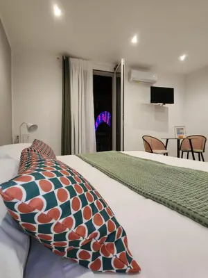 a bedroom with a bed with a pillow and a table at SulCorsoRooms in Palermo