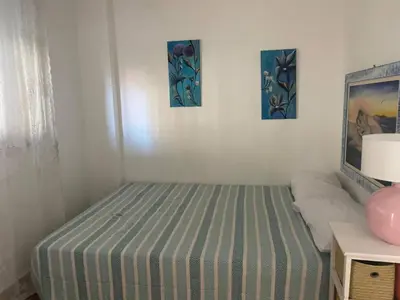 a bed in a room with three pictures on the wall at Casa del Sorriso in Isola delle Femmine