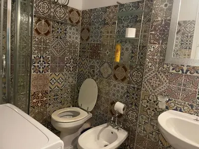 a bathroom with a toilet and a sink at Casa del Sorriso in Isola delle Femmine