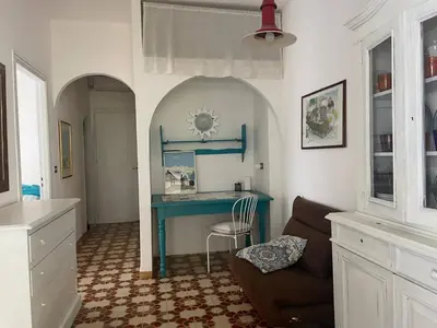 a living room with a blue desk and a chair at Casa del Sorriso in Isola delle Femmine