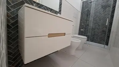 a bathroom with a toilet and a toilet paper dispenser at Casetta Giardinetto in Altavilla Milicia