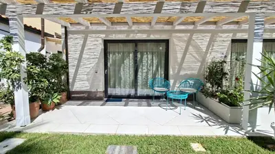 a patio with two chairs and a table at Casetta Giardinetto in Altavilla Milicia