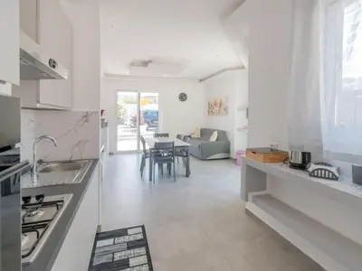 a kitchen and living room with a couch and a table at Luxury Villa Sicula Trabia in Trabia