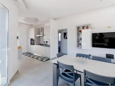 a kitchen and dining room with a table and chairs at Luxury Villa Sicula Trabia in Trabia