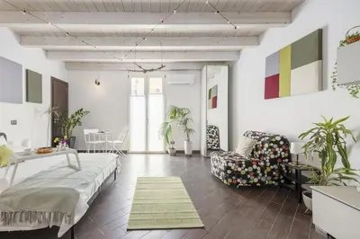 a living room with a couch and a chair at Mama apt - Comfort & style in Partanna Mondello in Palermo