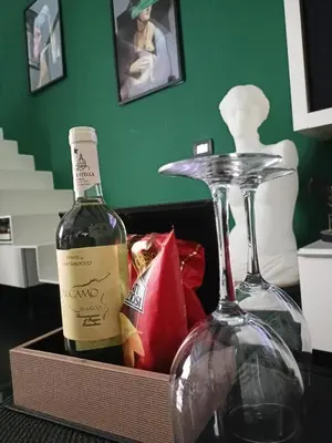 a box with a bottle of wine and two glasses at Dimora Stella Boutique in Alcamo