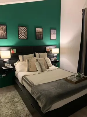 a bedroom with a green wall and a large bed at Dimora Stella Boutique in Alcamo