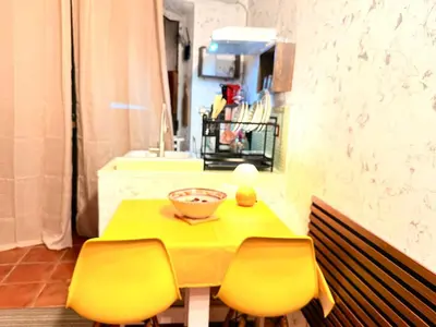 a yellow table with two chairs and a bowl on it at La Casetta del Centro in Palermo