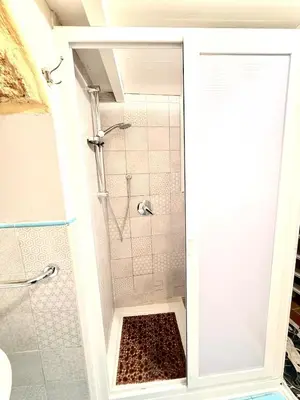a bathroom with a shower with a glass door at La Casetta del Centro in Palermo