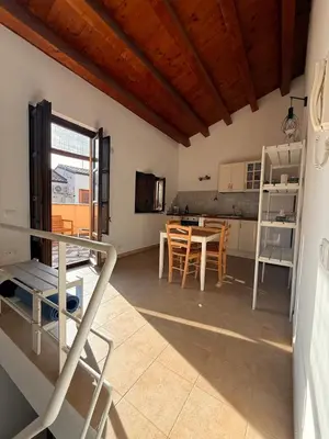 a kitchen and dining room with a table and chairs at Epic terrace in Kalsa in Palermo