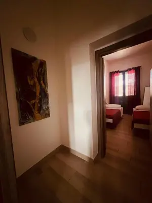a living room with a couch and a painting on the wall at AL CAPO casa vacanze in Palermo
